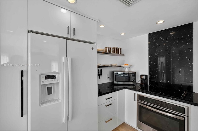 1600 S Bayshore Ln Unit 3A, Coconut Grove, FL 33133 - kitchen featuring appliances with stainless steel finishes, white cabinetry, dark countertops, open shelves, and recessed lighting