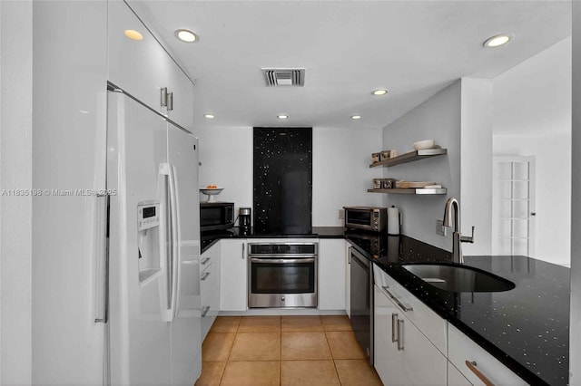 1600 S Bayshore Ln Unit 3A, Coconut Grove, FL 33133 - kitchen with stainless steel appliances, white cabinetry, open shelves, light tile patterned floors, and dark stone countertops