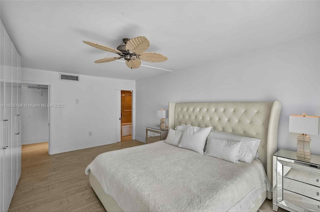 1600 S Bayshore Ln Unit 3A, Coconut Grove, FL 33133 - bedroom featuring wood finished floors, a walk in closet, and ceiling fan