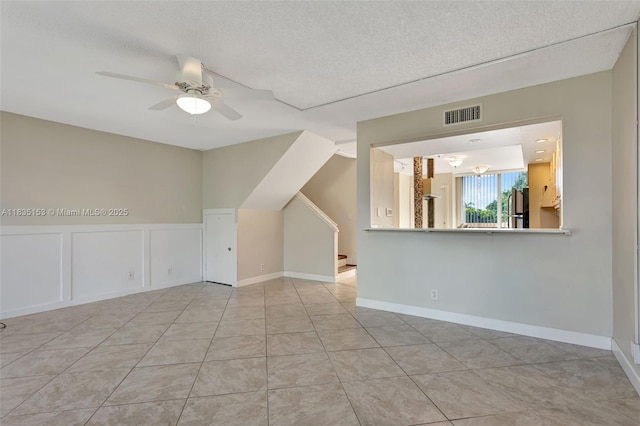 2921 SW 87th Ave Unit 511, Davie, FL 33328 - unfurnished living room with ceiling fan, stairs, a textured ceiling, and light tile patterned floors