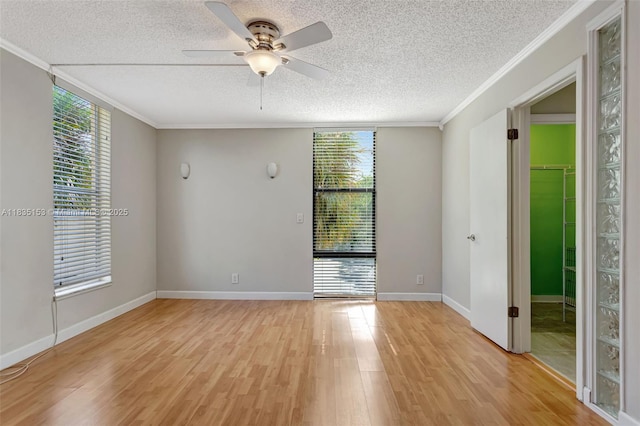 2921 SW 87th Ave Unit 511, Davie, FL 33328 - unfurnished room featuring a textured ceiling, ornamental molding, light wood-style flooring, and a ceiling fan