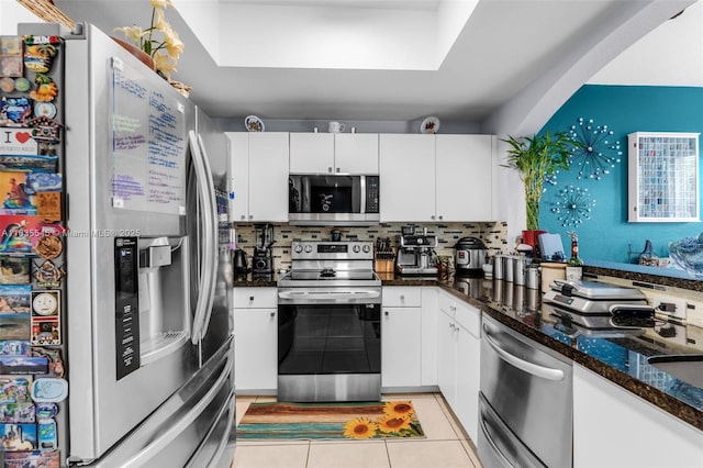 8956 W Flagler St Unit 203, Miami, FL 33174 - kitchen with appliances with stainless steel finishes, white cabinetry, and tasteful backsplash