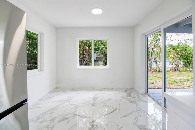6541 SW 8th St, North Lauderdale, FL 33068 - empty room with healthy amount of natural light and marble finish flooring