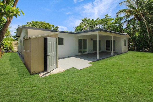 6541 SW 8th St, North Lauderdale, FL 33068 - back of property featuring a patio area, a lawn, and stucco siding