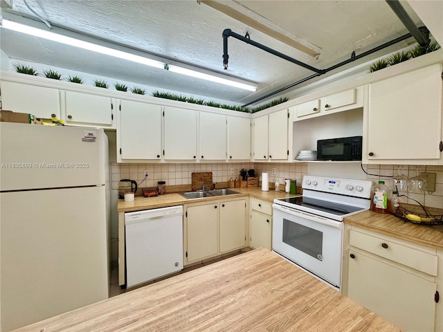 210 174th St Unit 1215, Sunny Isles Beach, FL 33160 - kitchen featuring white appliances, decorative backsplash, light countertops, and light wood finished floors