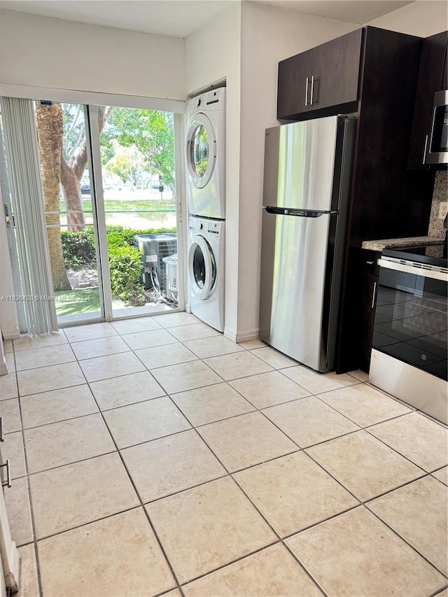 7900 NW 6th St Unit 102, Pembroke Pines, FL 33024 - laundry area with stacked washing machine and dryer, light tile patterned flooring, and plenty of natural light