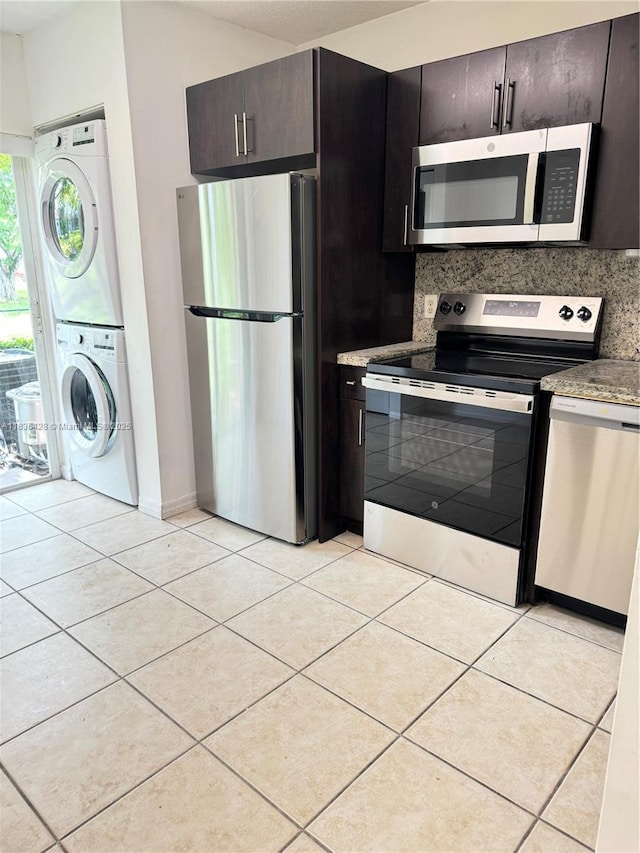 7900 NW 6th St Unit 102, Pembroke Pines, FL 33024 - kitchen with appliances with stainless steel finishes, stacked washer / drying machine, and light tile patterned flooring