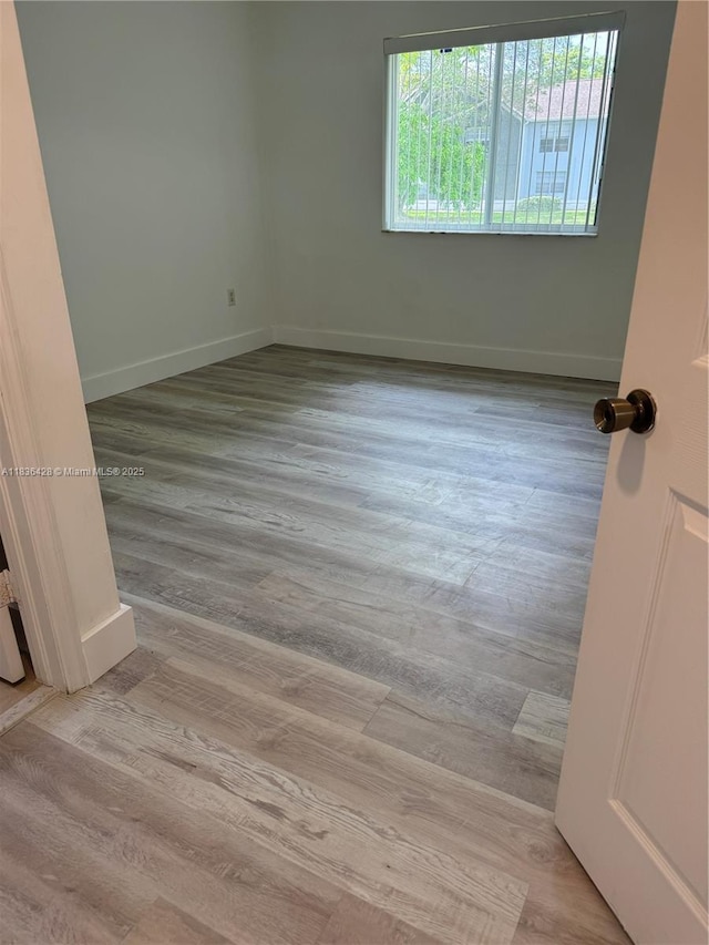 7900 NW 6th St Unit 102, Pembroke Pines, FL 33024 - unfurnished room featuring wood finished floors and baseboards
