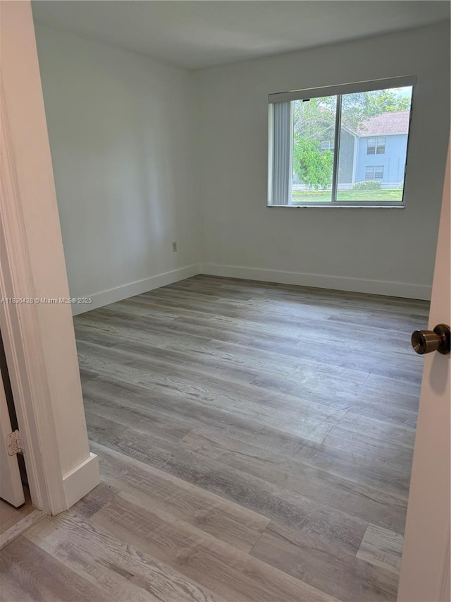 7900 NW 6th St Unit 102, Pembroke Pines, FL 33024 - empty room with wood finished floors and baseboards
