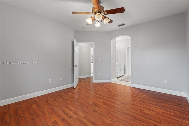 12720 SW 49th Ct, Miramar, FL 33027 - spare room featuring arched walkways, a ceiling fan, and wood finished floors