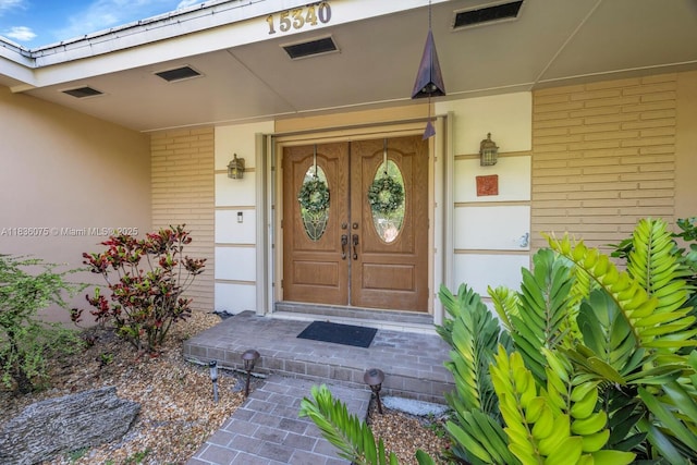 15340 SW 82nd Ave, Palmetto Bay, FL 33157 - entrance to property featuring brick siding, french doors, and covered porch