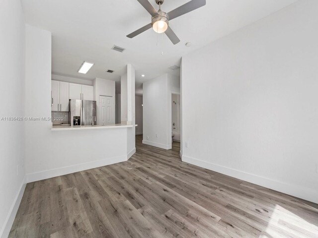 1456 SE 26th Ave, Homestead, FL 33035 - unfurnished living room with wood finished floors and a ceiling fan