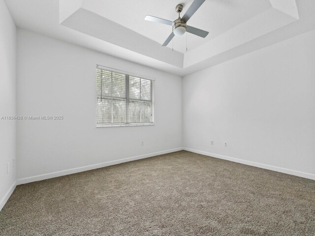1456 SE 26th Ave, Homestead, FL 33035 - spare room with a tray ceiling, carpet flooring, and a ceiling fan