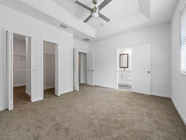 1456 SE 26th Ave, Homestead, FL 33035 - unfurnished bedroom with carpet flooring, connected bathroom, a raised ceiling, and a ceiling fan
