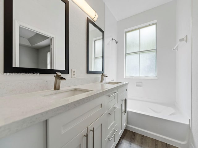 1456 SE 26th Ave, Homestead, FL 33035 - bathroom featuring double vanity, wood finished floors, and shower / tub combination