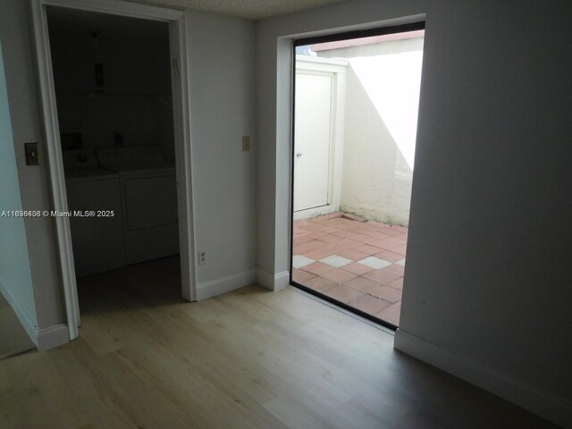 323 Ives Dairy Rd Unit 323-06, Miami, FL 33179 - unfurnished bedroom featuring independent washer and dryer and light wood-style floors