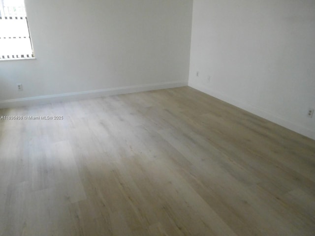 323 Ives Dairy Rd Unit 323-06, Miami, FL 33179 - spare room with light wood-style flooring