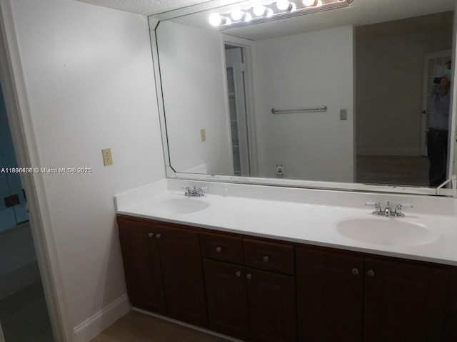 323 Ives Dairy Rd Unit 323-06, Miami, FL 33179 - full bathroom with double vanity and baseboards