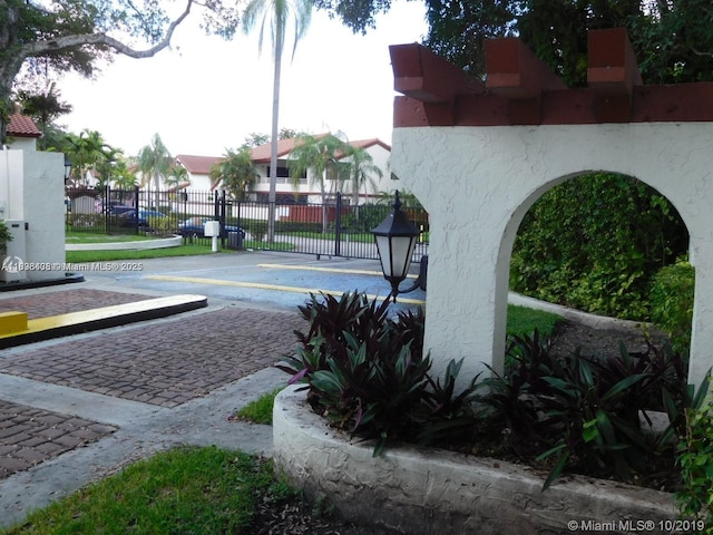 323 Ives Dairy Rd Unit 323-06, Miami, FL 33179 - view of road with a gated entry and a residential view