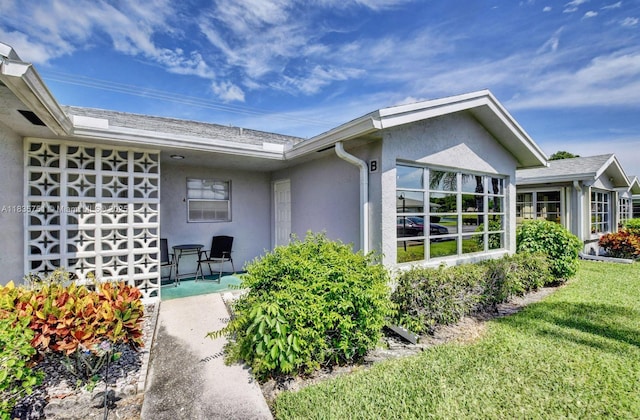 14529 Canalview Dr Unit B, Delray Beach, FL 33484 - view of home's exterior with stucco siding and a lawn