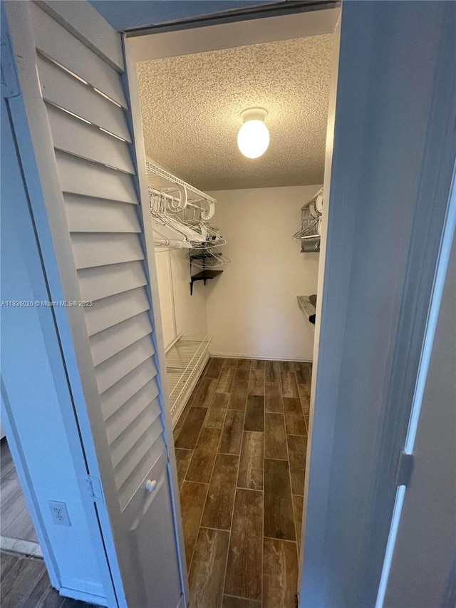 2173 NW 78th Ave Unit 103, Pembroke Pines, FL 33024 - walk in closet with dark wood-style floors