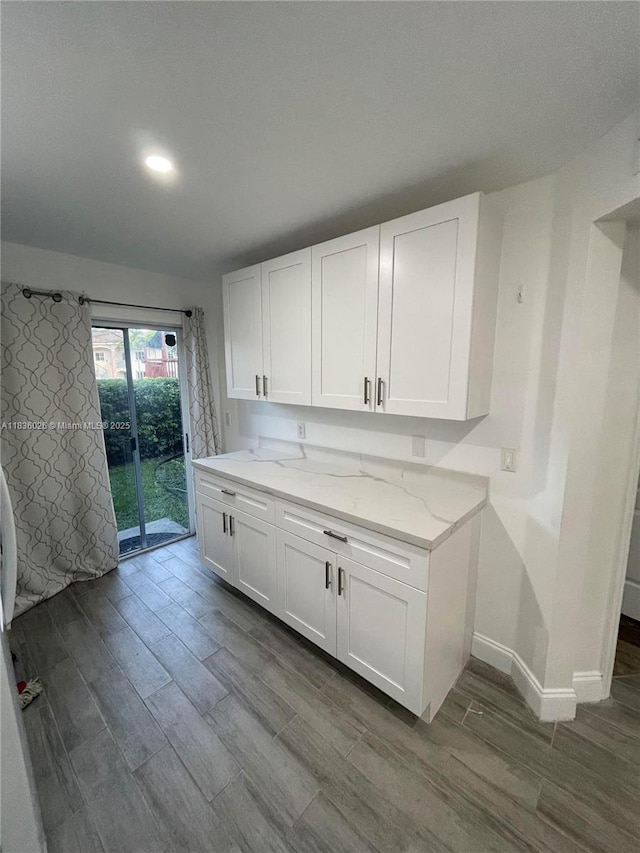 2173 NW 78th Ave Unit 103, Pembroke Pines, FL 33024 - kitchen with dark wood finished floors, light stone counters, white cabinetry, and recessed lighting