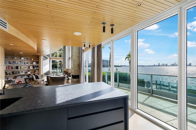 1331 Brickell Bay Dr Unit Bl-21, Miami, FL 33131 - kitchen featuring expansive windows, wooden ceiling, a water view, and dark countertops