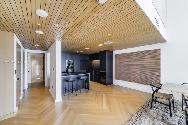 1331 Brickell Bay Dr Unit Bl-21, Miami, FL 33131 - kitchen featuring a kitchen breakfast bar, dark countertops, recessed lighting, wooden ceiling, and oven