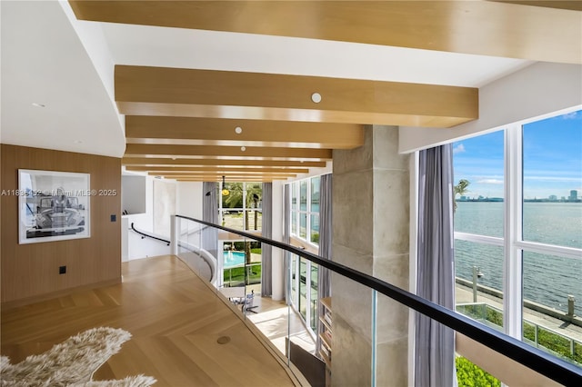 1331 Brickell Bay Dr Unit Bl-21, Miami, FL 33131 - hallway with a water view, an upstairs landing, wooden walls, and beam ceiling