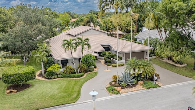 9099 NW 47th Ct, Coral Springs, FL 33067 - view of front of property featuring concrete driveway, an attached garage, a front yard, and a tile roof