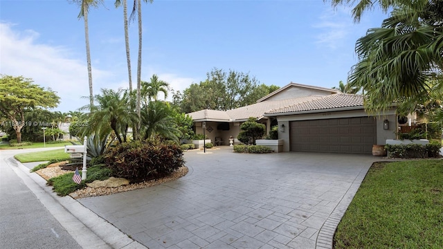 9099 NW 47th Ct, Coral Springs, FL 33067 - single story home with a garage, stucco siding, decorative driveway, and a tiled roof