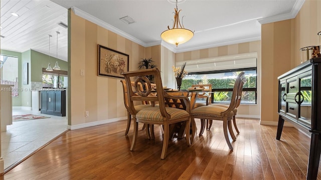 9099 NW 47th Ct, Coral Springs, FL 33067 - dining space with healthy amount of natural light, hardwood / wood-style floors, and crown molding