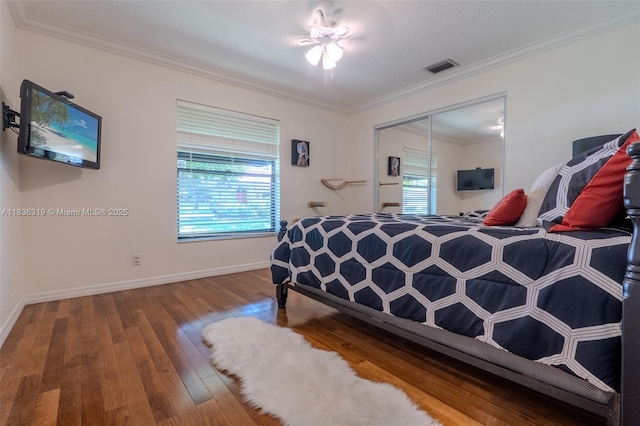 9099 NW 47th Ct, Coral Springs, FL 33067 - bedroom with multiple windows, ornamental molding, hardwood / wood-style flooring, and a closet