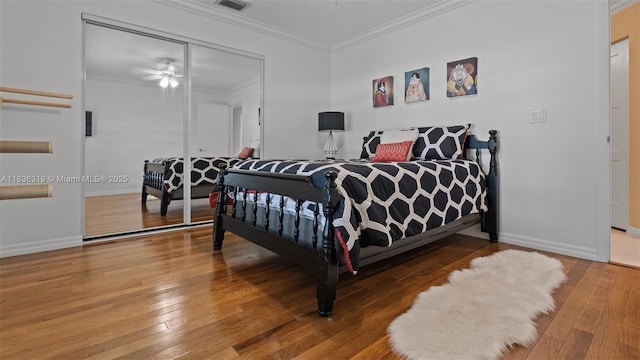 9099 NW 47th Ct, Coral Springs, FL 33067 - bedroom featuring ornamental molding, wood-type flooring, and a closet