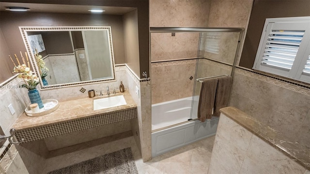 9099 NW 47th Ct, Coral Springs, FL 33067 - full bathroom with tile walls, vanity, enclosed tub / shower combo, and wainscoting