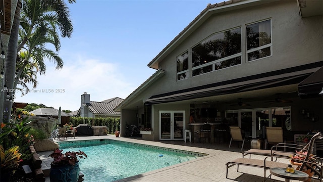9099 NW 47th Ct, Coral Springs, FL 33067 - outdoor pool featuring a patio, ceiling fan, and french doors