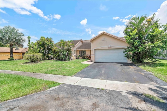 8250 NW 51st Ct, Lauderhill, FL 33351 - view of front facade with stucco siding, driveway, a front lawn, and an attached garage