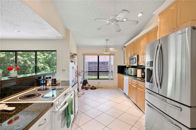 8250 NW 51st Ct, Lauderhill, FL 33351 - kitchen with stainless steel appliances, a textured ceiling, dark countertops, light tile patterned floors, and light brown cabinetry