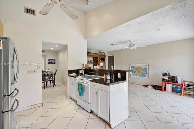 8250 NW 51st Ct, Lauderhill, FL 33351 - kitchen with white electric stove, ceiling fan, freestanding refrigerator, dark countertops, and light tile patterned flooring