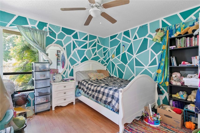 8250 NW 51st Ct, Lauderhill, FL 33351 - bedroom featuring light wood finished floors, a textured ceiling, wallpapered walls, and ceiling fan