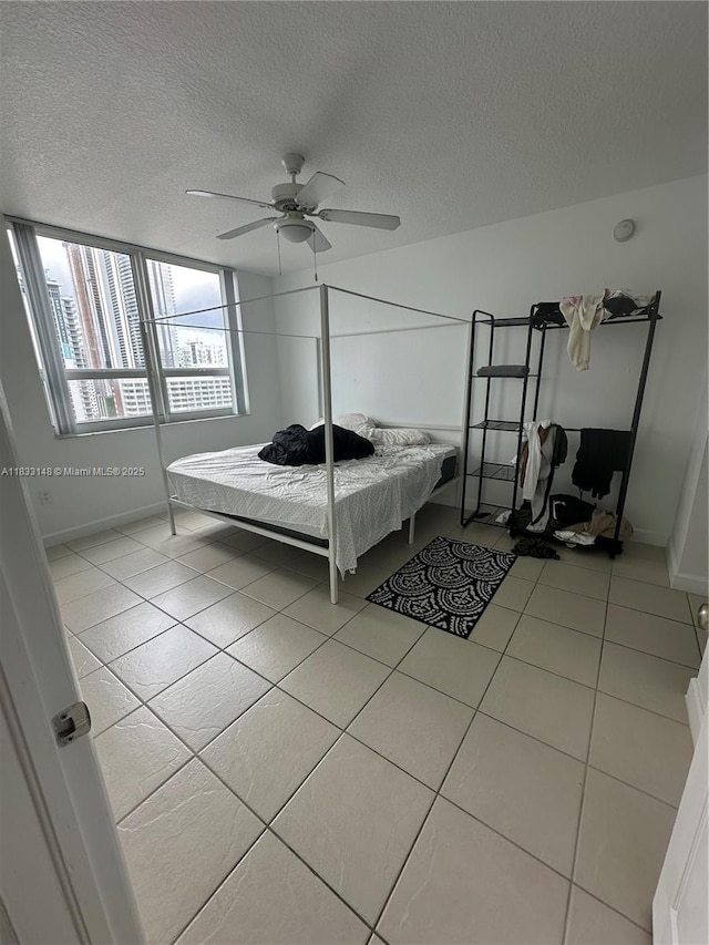 2000 N Bayshore Dr Unit 1505, Miami, FL 33137 - bedroom with light tile patterned floors, a textured ceiling, and a ceiling fan