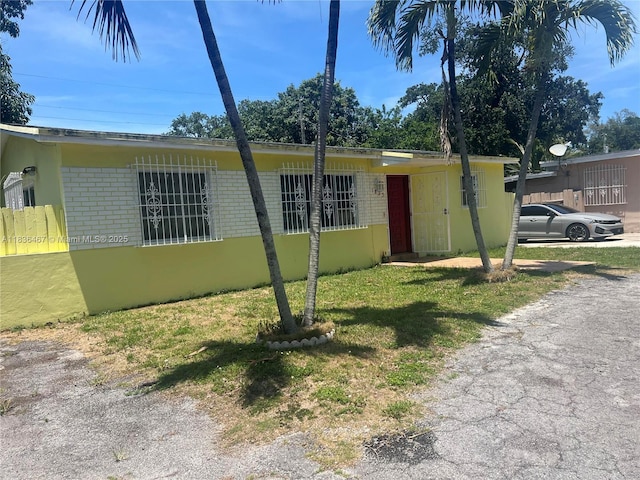 1825 NW 112th St, Miami, FL 33167 - view of front of property with brick siding and a front lawn