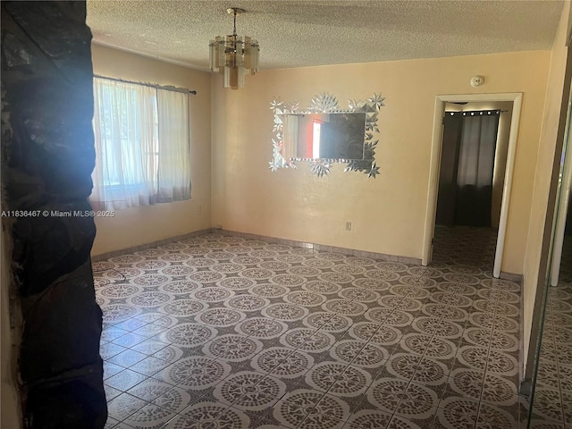 1825 NW 112th St, Miami, FL 33167 - empty room with a textured ceiling, a chandelier, and a smoke detector