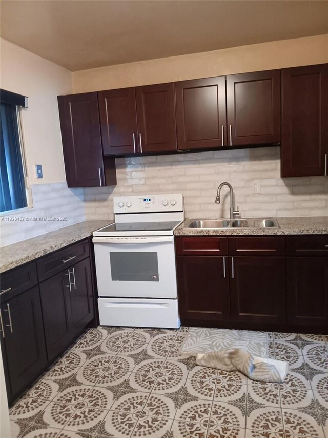1825 NW 112th St, Miami, FL 33167 - kitchen with electric stove, decorative backsplash, light tile patterned floors, and dark brown cabinetry