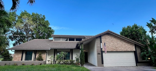 8924 47th Ct, Coral Springs, FL 33067 - view of front facade with stone siding, a tiled roof, and stucco siding