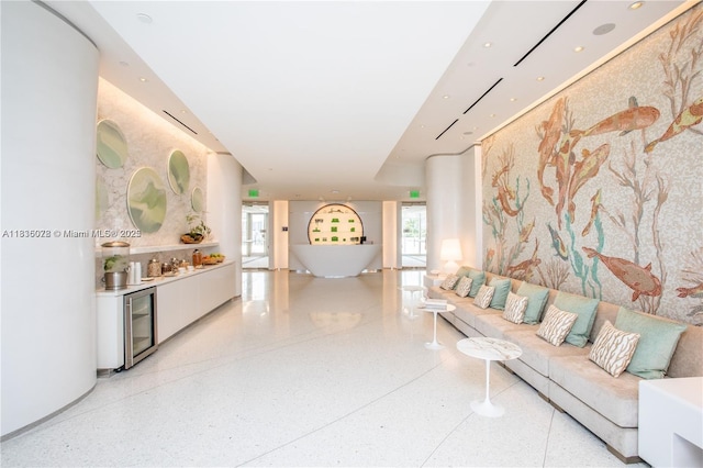 16901 Collins Ave Unit 2702, Sunny Isles Beach, FL 33160 - living room featuring wine cooler, a bar, and dark aggregate flooring