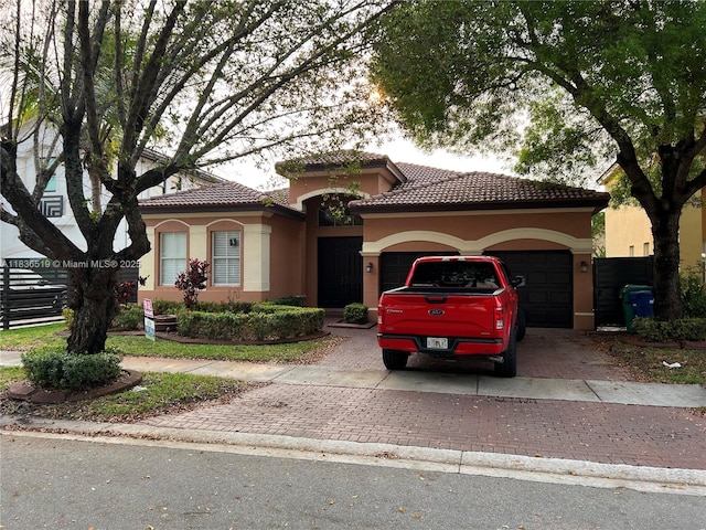 18122 NW 91st Ct, Hialeah, FL 33018 - mediterranean / spanish home with a garage, stucco siding, decorative driveway, and a tile roof