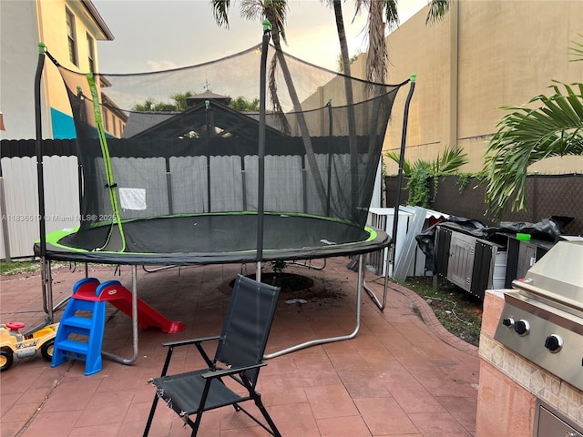 18122 NW 91st Ct, Hialeah, FL 33018 - fenced backyard with a trampoline and a patio