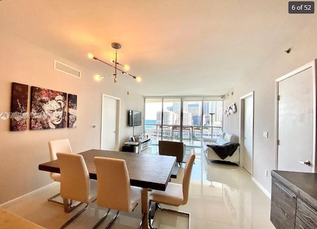 495 Brickell Ave Unit 1205, Miami, FL 33131 - dining room with a chandelier and a wall of windows