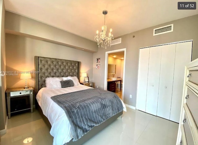 495 Brickell Ave Unit 1205, Miami, FL 33131 - bedroom featuring a chandelier, a closet, connected bathroom, and tile patterned floors